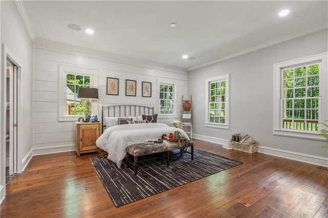 bedroom with dark wood-type flooring, ornamental molding, and multiple windows