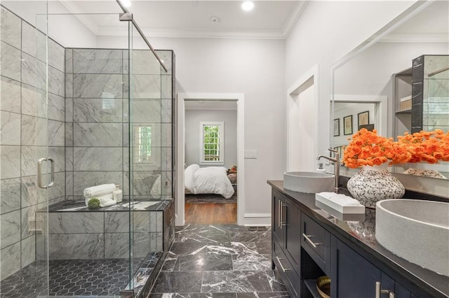 ensuite bathroom with marble finish floor, a sink, a shower stall, crown molding, and double vanity