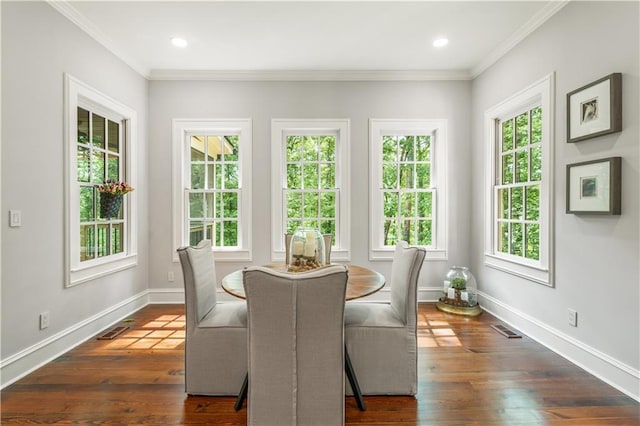 dining space with visible vents, baseboards, dark wood-type flooring, and ornamental molding