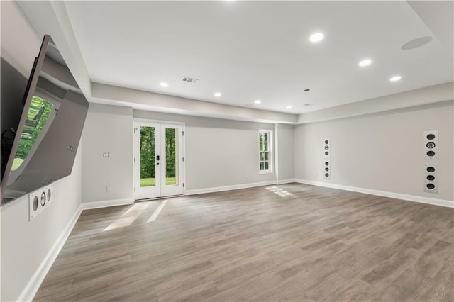 unfurnished room featuring recessed lighting, french doors, baseboards, and wood finished floors