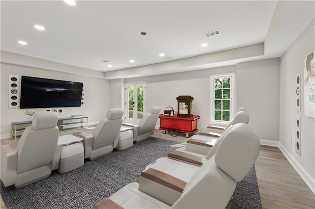 living room with recessed lighting, visible vents, baseboards, and wood finished floors