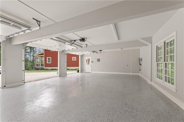 garage with baseboards and a garage door opener