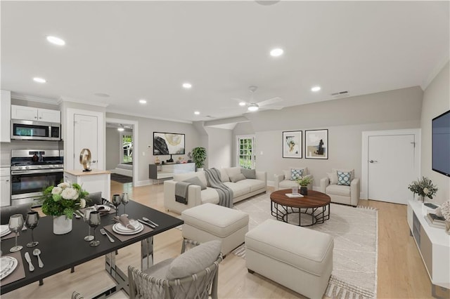 living room featuring ceiling fan, light hardwood / wood-style flooring, and ornamental molding