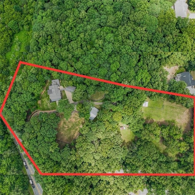 birds eye view of property with a view of trees