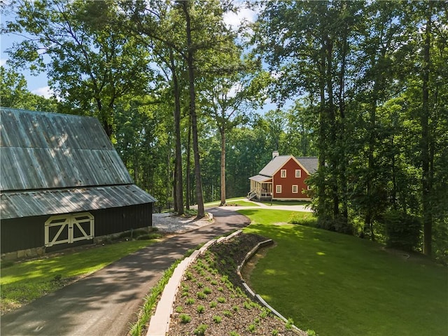 view of yard featuring a barn and an outdoor structure