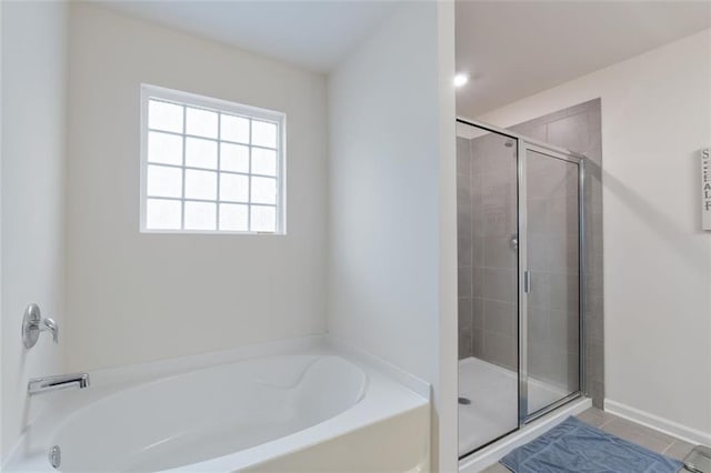 5755 Turnstone Trl, Flowery Branch, GA 30542 - full bathroom featuring a garden tub, a stall shower, and tile patterned floors