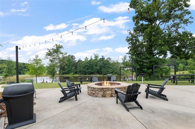 5755 Turnstone Trl, Flowery Branch, GA 30542 - view of patio featuring an outdoor fire pit, a water view, and view of scattered trees