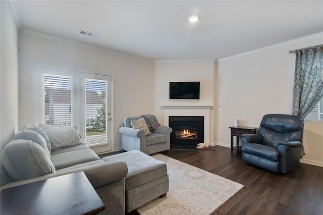 5755 Turnstone Trl, Flowery Branch, GA 30542 - living area featuring dark wood-type flooring, ornamental molding, healthy amount of natural light, a warm lit fireplace, and baseboards