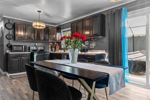 5143 3rd St, Morrow, GA 30260 - kitchen featuring stainless steel range with electric cooktop, light wood-style flooring, dark brown cabinets, black microwave, and light countertops