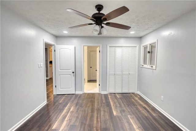 unfurnished bedroom featuring baseboards, wood finished floors, a closet, a textured ceiling, and recessed lighting