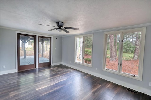 spare room featuring dark wood-style floors, baseboards, a textured ceiling, ornamental molding, and ceiling fan