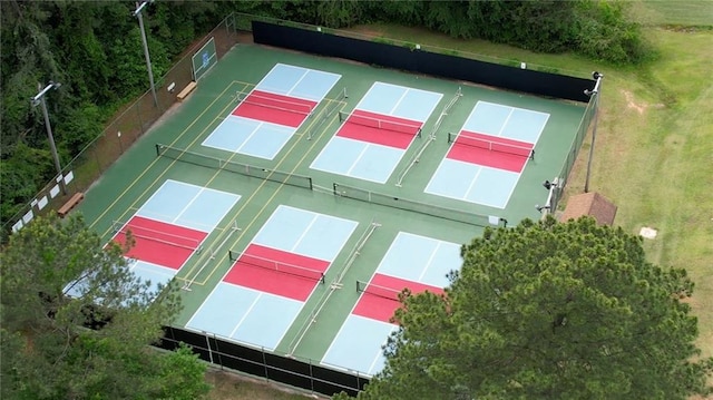 view of sport court featuring a tennis court and fence