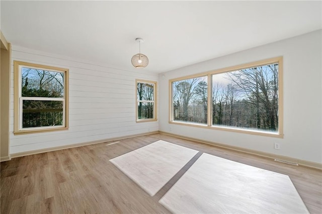 unfurnished sunroom with visible vents