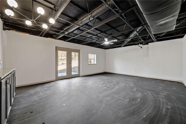 spare room with french doors, concrete floors, and baseboards