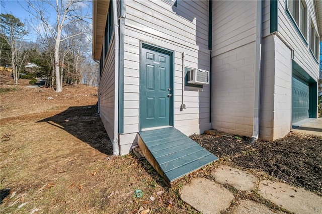 doorway to property with a wall mounted AC