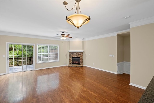 5159 Wellsley Bnd, Alpharetta, GA 30005 - unfurnished living room featuring wood finished floors, ornamental molding, ceiling fan, a stone fireplace, and baseboards