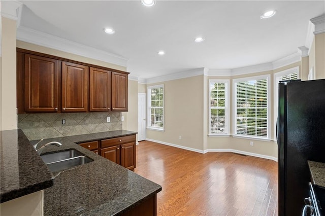 5159 Wellsley Bnd, Alpharetta, GA 30005 - kitchen with freestanding refrigerator, a sink, light wood-type flooring, crown molding, and baseboards