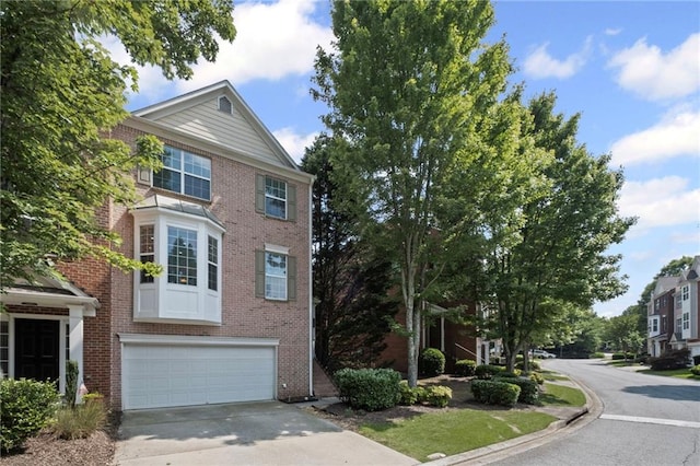 5159 Wellsley Bnd, Alpharetta, GA 30005 - view of front facade with concrete driveway, brick siding, and an attached garage