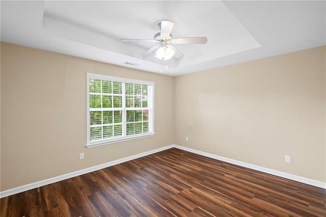 5159 Wellsley Bnd, Alpharetta, GA 30005 - spare room with baseboards, a tray ceiling, dark wood finished floors, and ceiling fan