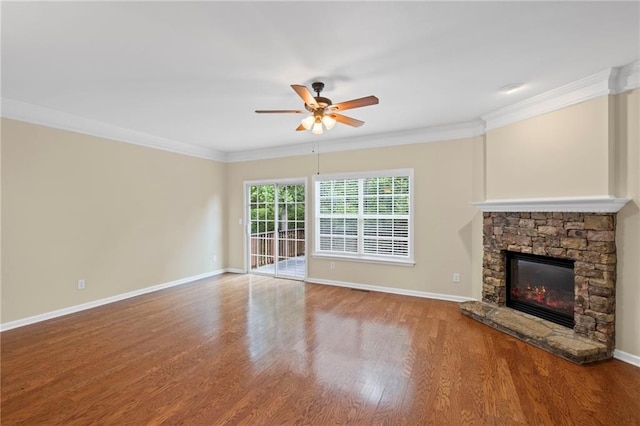 5159 Wellsley Bnd, Alpharetta, GA 30005 - unfurnished living room featuring a ceiling fan, wood finished floors, baseboards, a stone fireplace, and ornamental molding