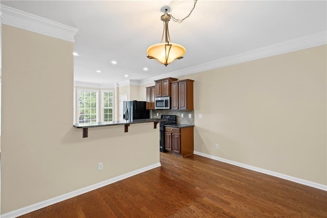 5159 Wellsley Bnd, Alpharetta, GA 30005 - kitchen featuring stainless steel microwave, fridge with ice dispenser, a breakfast bar, dark countertops, and crown molding