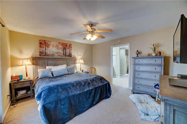 carpeted bedroom featuring ensuite bath and ceiling fan