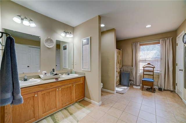 bathroom featuring tile patterned floors, vanity, and toilet