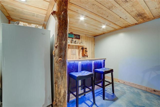 bar featuring carpet and wooden ceiling