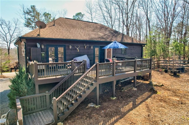 rear view of property featuring french doors and a deck