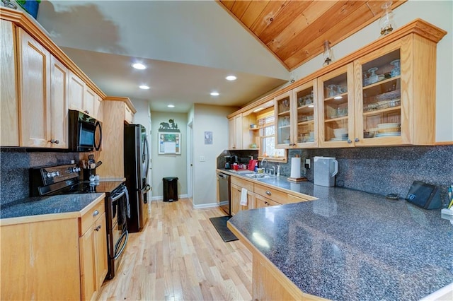 kitchen with black appliances, light hardwood / wood-style flooring, light brown cabinetry, and vaulted ceiling