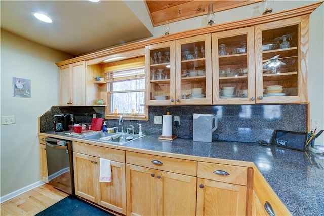 kitchen featuring sink, black dishwasher, backsplash, light brown cabinetry, and light wood-type flooring