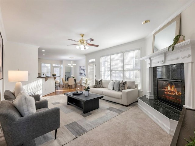 2750 Olde Towne Pkwy, Duluth, GA 30097 - living area featuring a ceiling fan, a tiled fireplace, light carpet, baseboards, and crown molding