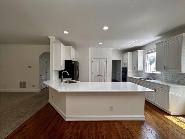 2750 Olde Towne Pkwy, Duluth, GA 30097 - kitchen with a peninsula, black appliances, a sink, backsplash, and recessed lighting