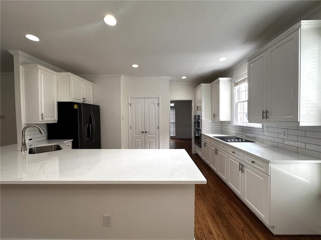2750 Olde Towne Pkwy, Duluth, GA 30097 - kitchen with black appliances, a sink, a peninsula, tasteful backsplash, and white cabinets