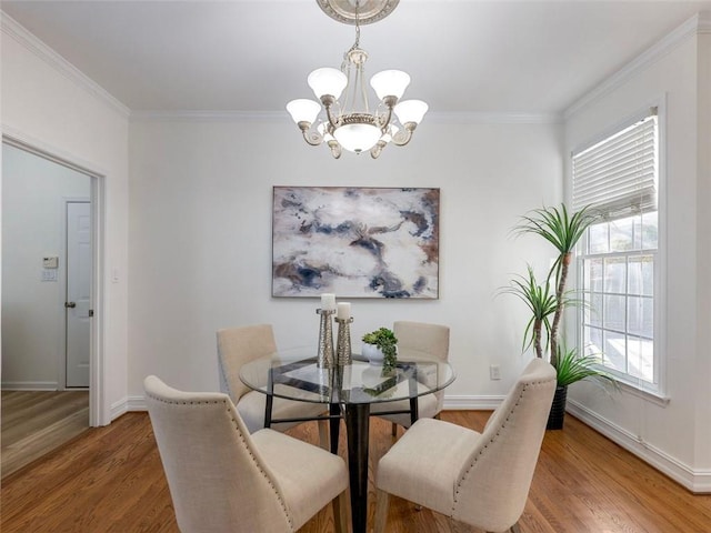 2750 Olde Towne Pkwy, Duluth, GA 30097 - dining area with a chandelier, wood finished floors, crown molding, and baseboards