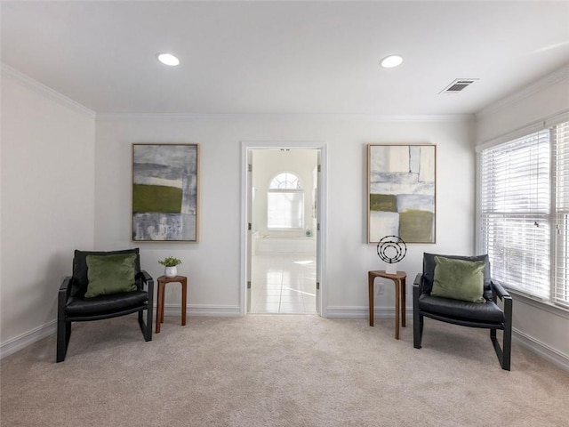 sitting room with light colored carpet and ornamental molding