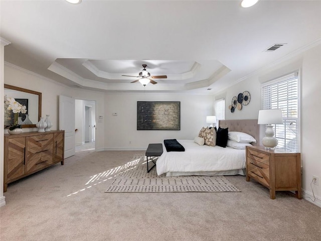 carpeted bedroom with a raised ceiling, ceiling fan, and crown molding