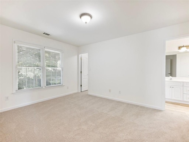 unfurnished room featuring light colored carpet