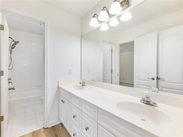 2750 Olde Towne Pkwy, Duluth, GA 30097 - bathroom featuring double vanity, shower / washtub combination, wood finished floors, and baseboards