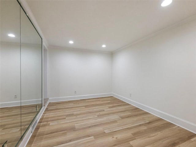 unfurnished room featuring light hardwood / wood-style floors and ornamental molding