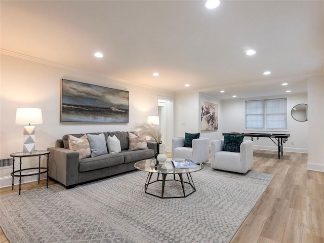 living room featuring light hardwood / wood-style flooring and ornamental molding