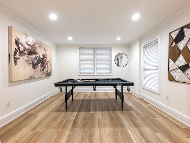 recreation room with hardwood / wood-style floors and ornamental molding