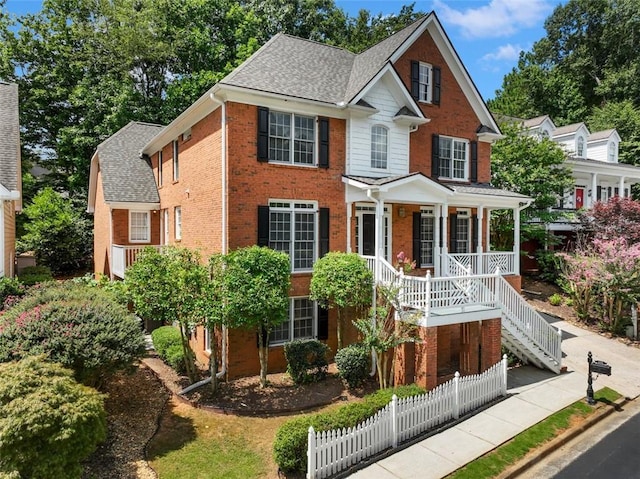 2750 Olde Towne Pkwy, Duluth, GA 30097 - view of front facade with brick siding, covered porch, a shingled roof, and stairs