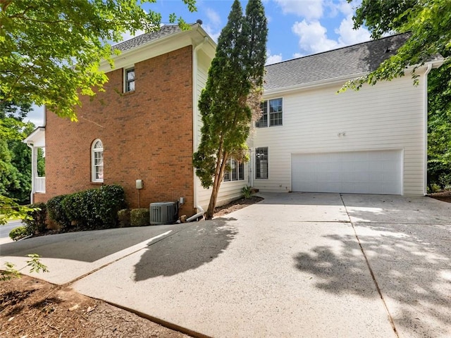 exterior space with cooling unit and a garage