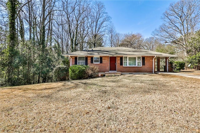 ranch-style house featuring driveway, a front lawn, and brick siding