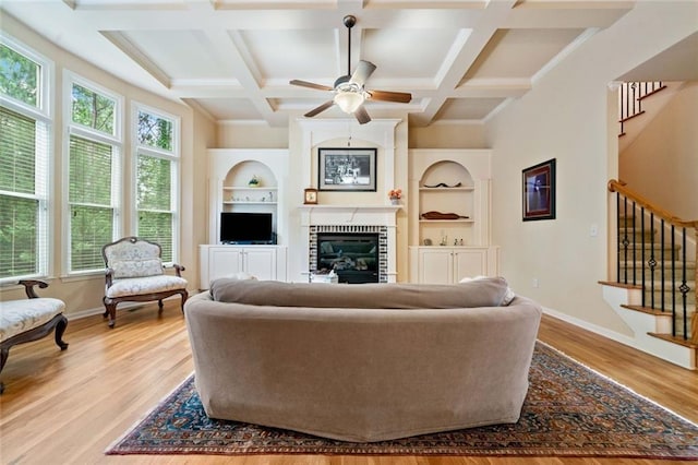 1898 Alcovy Shoals Blf SE, Lawrenceville, GA 30045 - living area with stairway, built in shelves, a brick fireplace, beamed ceiling, and coffered ceiling