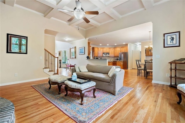 1898 Alcovy Shoals Blf SE, Lawrenceville, GA 30045 - living area with light wood finished floors, beam ceiling, stairway, baseboards, and ornamental molding