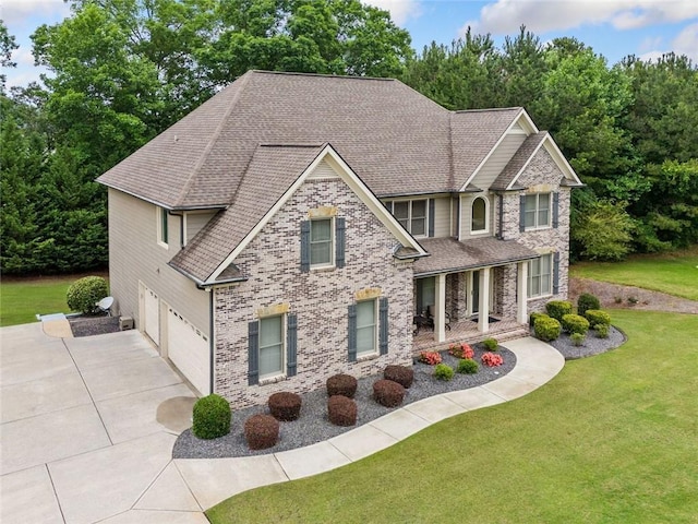 1898 Alcovy Shoals Blf SE, Lawrenceville, GA 30045 - view of front of home with an attached garage, concrete driveway, a shingled roof, and a front yard