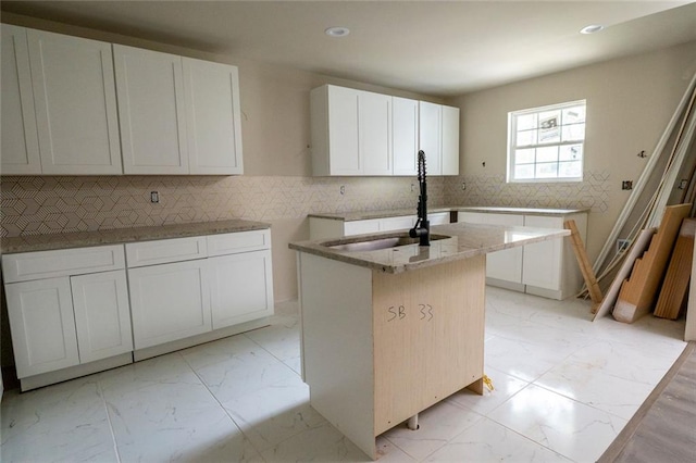 2191 Camp Ground Rd, Atlanta, GA 30331 - kitchen with an island with sink, recessed lighting, light stone counters, marble finish floor, and a sink
