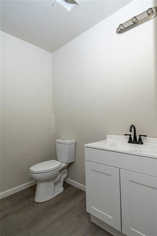 2191 Camp Ground Rd, Atlanta, GA 30331 - half bathroom featuring toilet, wood finished floors, vanity, and baseboards